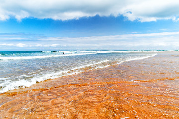 Shallow water on the sandy sea beach.