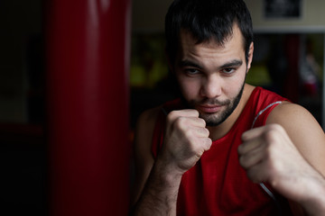 Boxing. Portrait of a boxer on the background of the gym