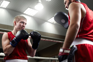 Fototapeta na wymiar Boxing. Two guys boxer train in the gym