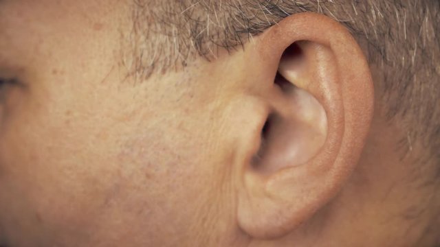 Man left ear. Macro extreme close up view of male ear. Concept for audio music sound health human ear.