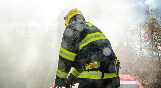 Firefighters with a hose in action