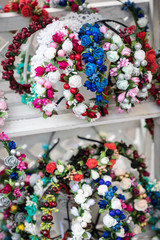 Colorful traditional flower wreath on sale on local market.