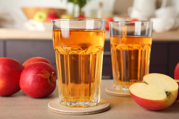 Glasses with apple juice on kitchen table