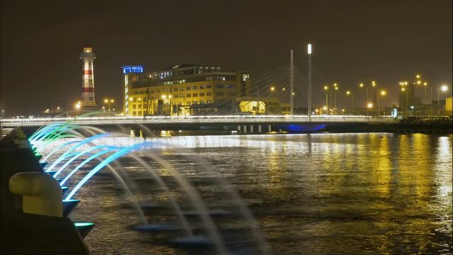 Timelapse at night of bridge lighthouse and a fountain