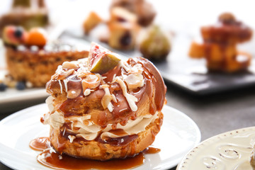 Delicious cake with caramel sauce on plate