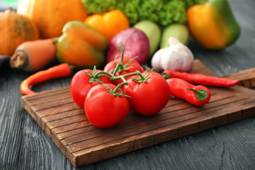 Fresh tomatoes on wooden board