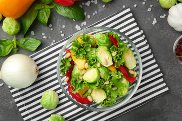 Bowl of tasty salad with Brussels sprouts on table