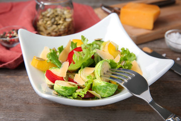 Plate of tasty salad with Brussels sprouts on table