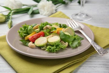 Plate of tasty salad with Brussels sprouts on table