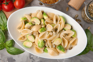 Plate of pasta with Brussels sprouts on table
