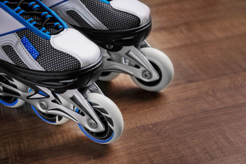 Pair of roller skates on wooden floor, closeup