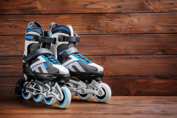 Pair of roller skates on wooden background