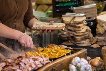 Food booth selling traditional Polish street food in Main Square, Kraków at Christmas market.