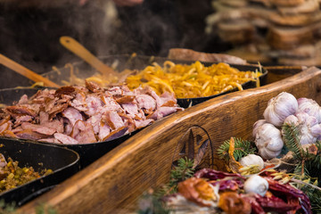 Food booth selling traditional Polish street food in Main Square, Kraków at Christmas market.