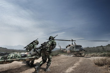 Thai Army Soldiers with full uniform carrying patient to the aircraft, military training