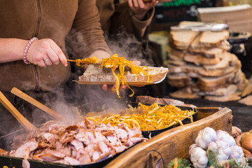 Food booth selling traditional Polish street food in Main Square, Kraków at Christmas market.