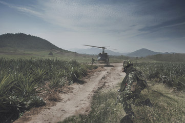 Thai Army Helicopter is landing on the open field operation site while the soldiers are preparing to jump up.