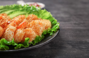 Plate with fresh tasty shrimp basket on table, closeup