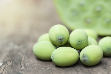 Lotus seed or lotus nut. Good for healthy and can eat both fresh and dried seed cooking as a food. Shooting on vintage wood surface table.