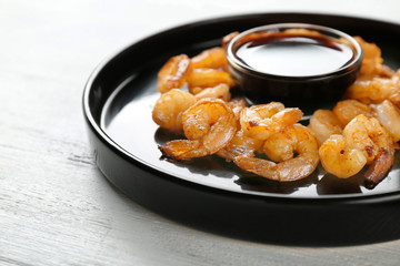 Plate with fresh tasty shrimp basket and sauce on table, closeup