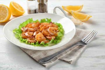 Plate with fresh tasty shrimp basket on table