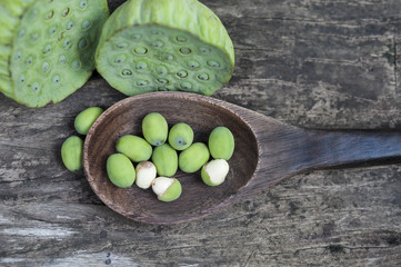 Lotus seed or lotus nut. Good for healthy and can eat both fresh and dried seed or cooking as a food. Shooting on vintage wood surface table.