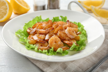 Plate with fresh tasty shrimp basket on table