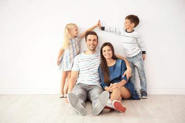 Happy family near wall in their new home