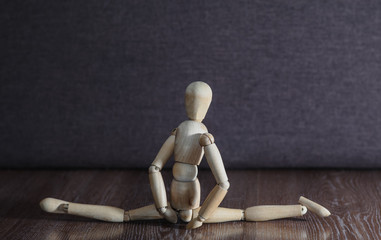 The girl does twine and demonstrates its flexibility. The concept. Wooden figure