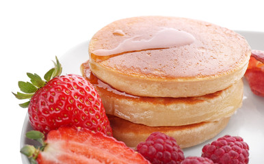 Tasty breakfast with pancakes and berries on white background, close up
