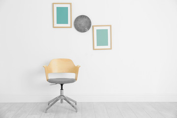 Comfortable armchair on white wall background