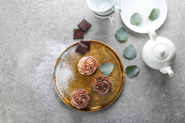 Fototapeta na wymiar Composition with tasty chocolate cupcakes on grey background