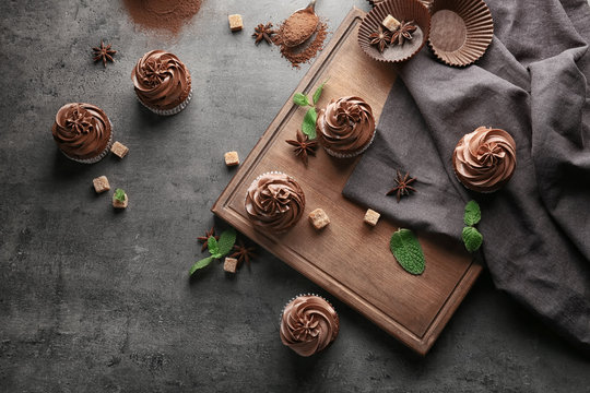 Composition with tasty chocolate cupcakes on dark background