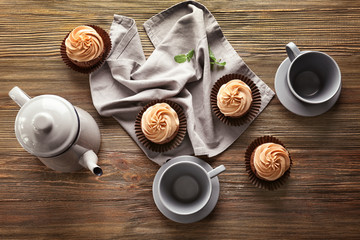 Composition with tasty chocolate cupcakes on wooden background