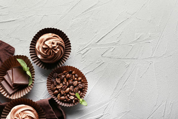 Composition with tasty chocolate cupcakes on textured background
