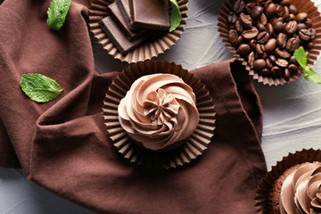 Composition with tasty chocolate cupcakes on textured background