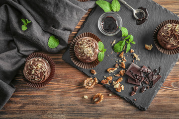 Composition with chocolate cupcakes on table
