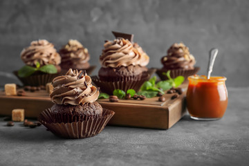 Composition with tasty chocolate cupcakes on grey background