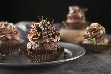 Tasty chocolate cupcake on metal tray