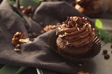 Tasty chocolate cupcake on table