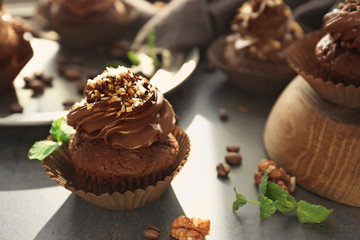 Tasty chocolate cupcake on table