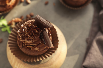 Tasty chocolate cupcake on table