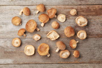 Raw shiitake mushrooms on wooden table