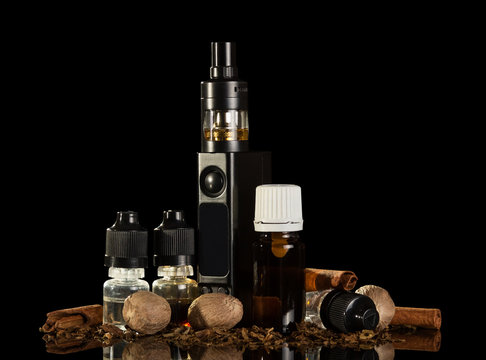 Electronic cigarette bottles with the liquid and spices for odor, isolated on black