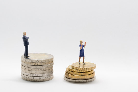 Business man and woman on coins - gender pay gap