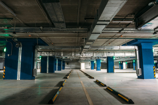 Large dark empty Underground garage or modern car parking, columns, tunnel vision, toned