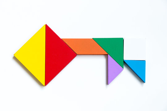 Colorful wood tangram puzzle in key shape on white background