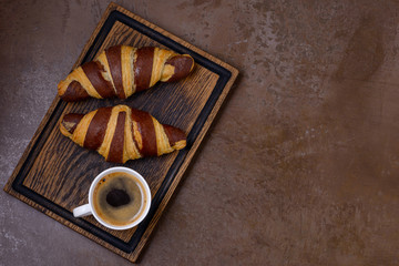 Black coffee and chocolate croissant