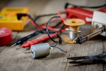 Electronic workshop. Electric meter and soldering iron.