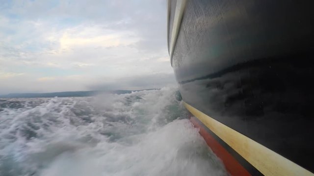 A low shot of a professional fishing boat moving through ocean